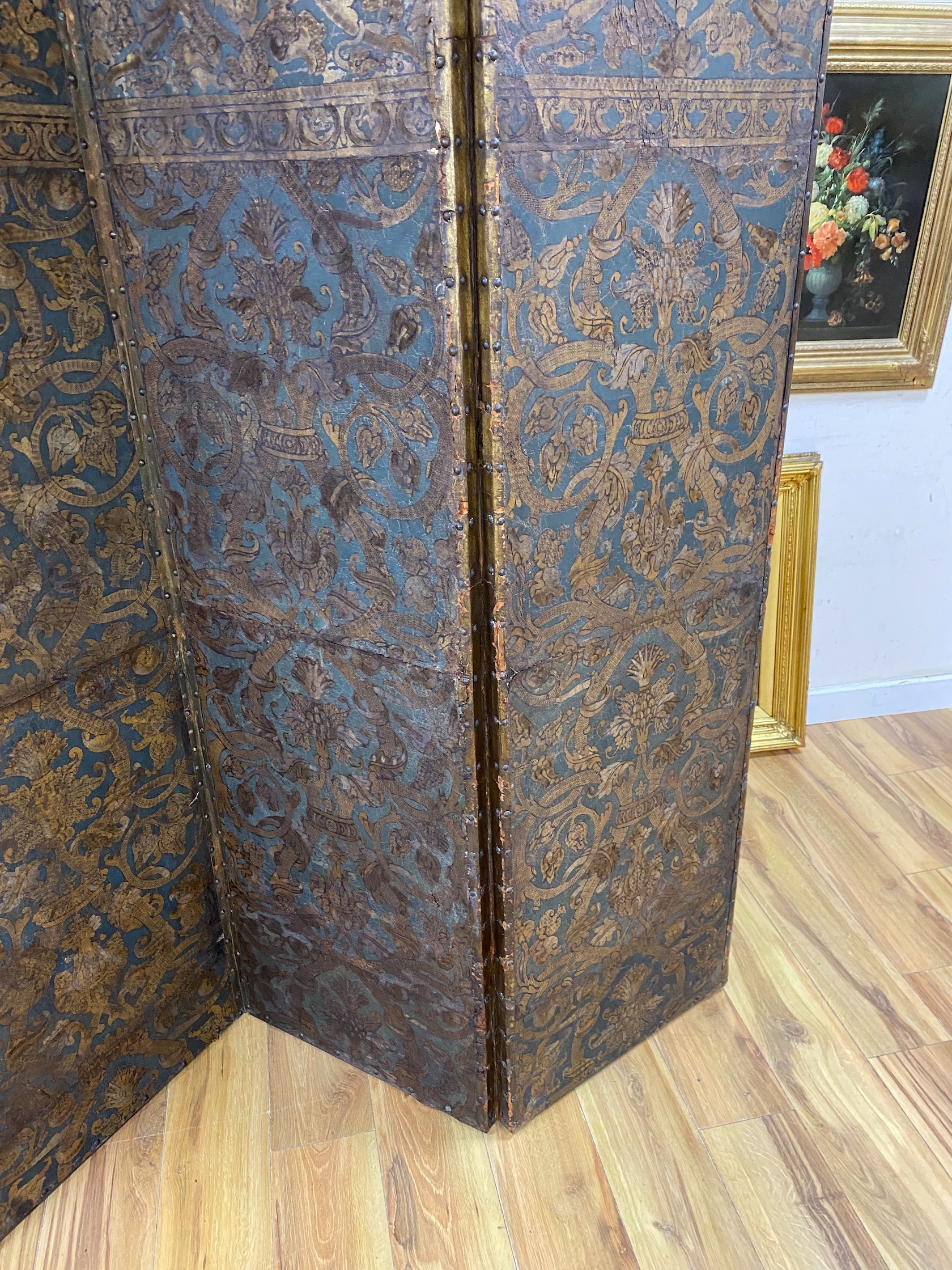 A 19th century French studded leather four fold screen, each panel width 49cm, height 182cm